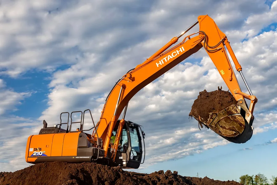 Excavator moving soil during site preparation.